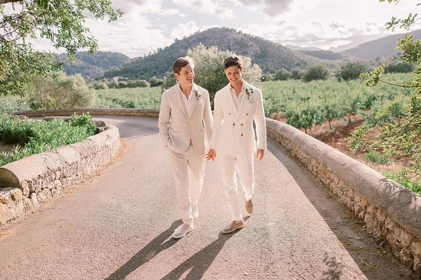 Adrian & Jack walking down the road at their destination wedding in Majorca how to Survive the Heat on Your Wedding Day Adrian & Jack walking down the road at their destination wedding in Majorca