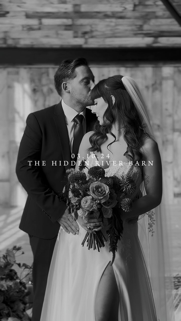 Lucy perched against wall holding camera, owner of Lucylou Photography - Hampshire Wedding Photographer