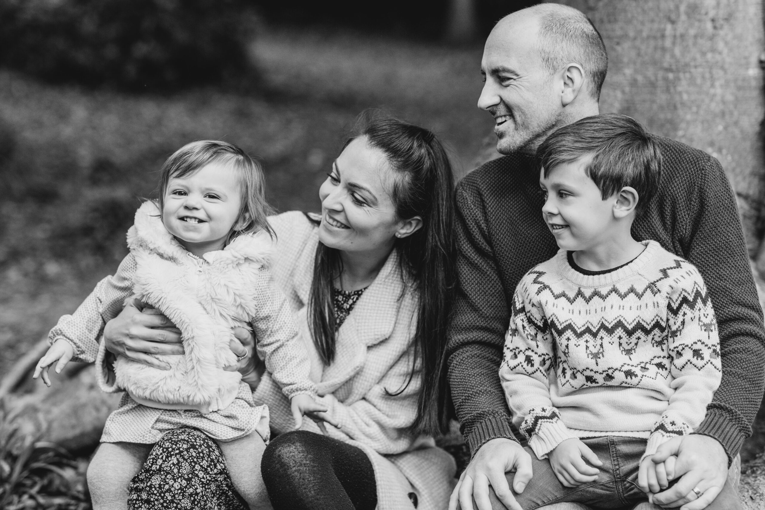 Black and white Family Photography Family Photography - black and white photo of family smiling and looking at eahcother