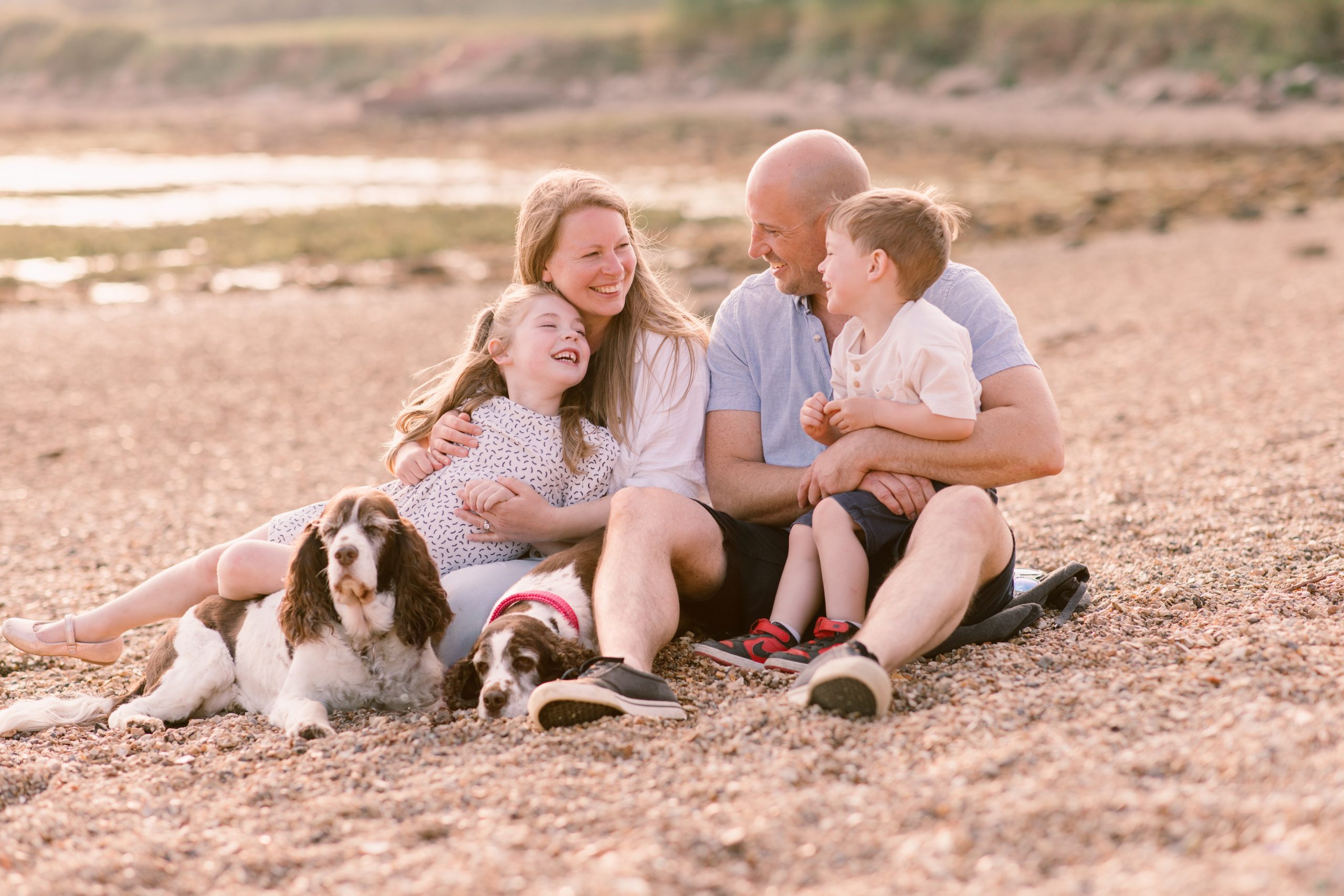 Hampshire Family Photographer Hampshire Family photographer - Young Family walking together through the woods and looking at each other