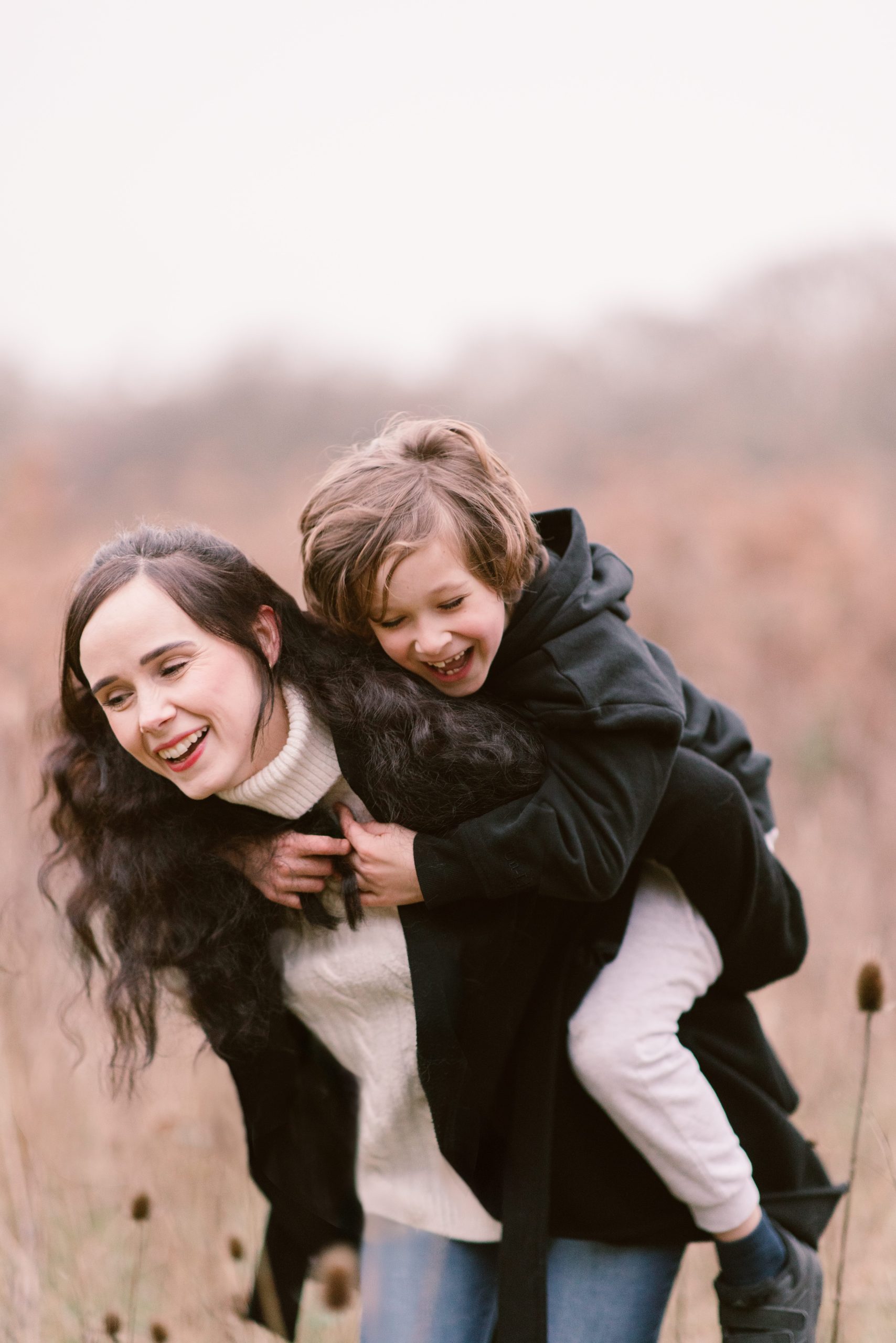 Hampshire Family photographer - Mother & son Hampshire Family photographer - Mother & son having a piggy back and a laugh together