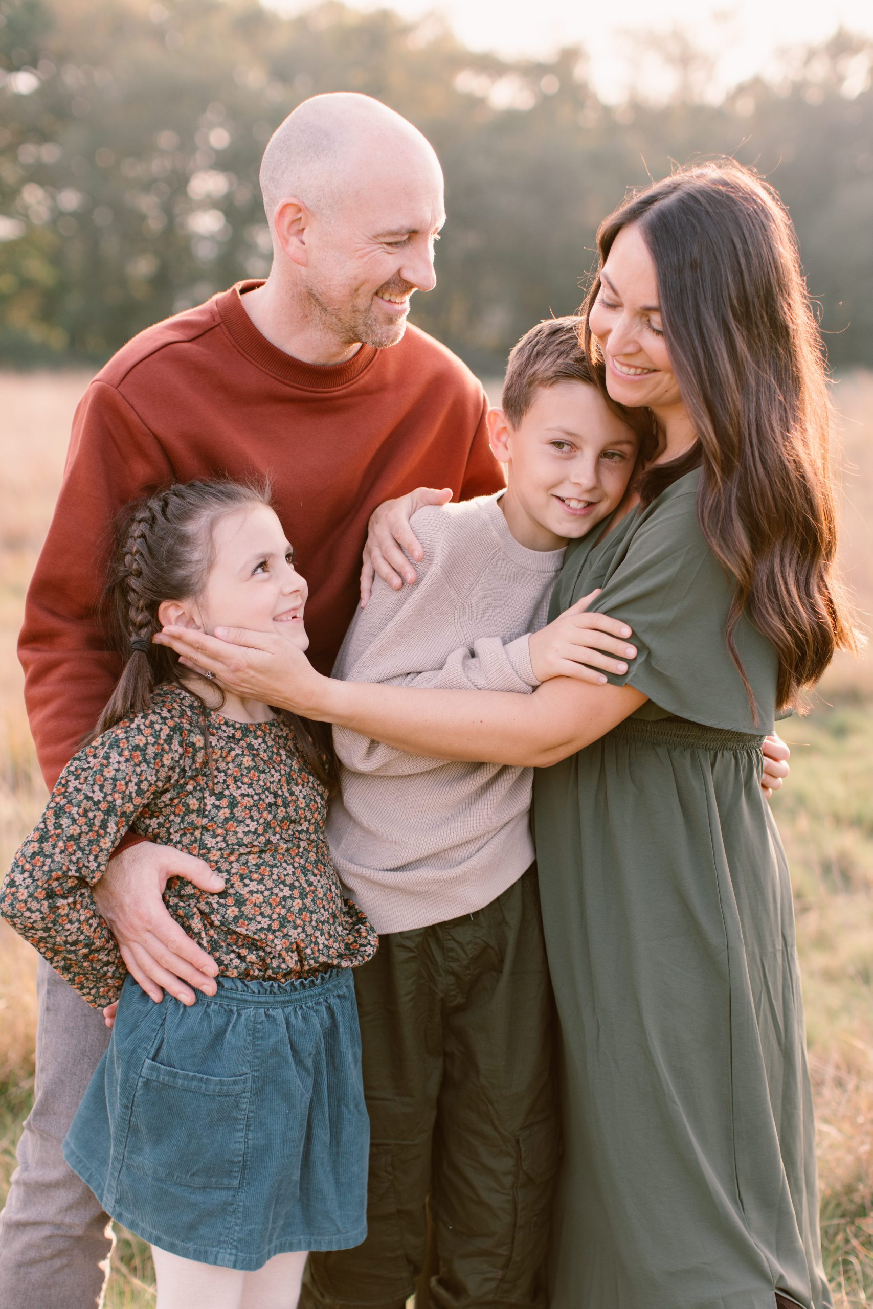 Hampshire Family Photographer Hampshire Family photographer - Young Family walking together through the woods and looking at each other